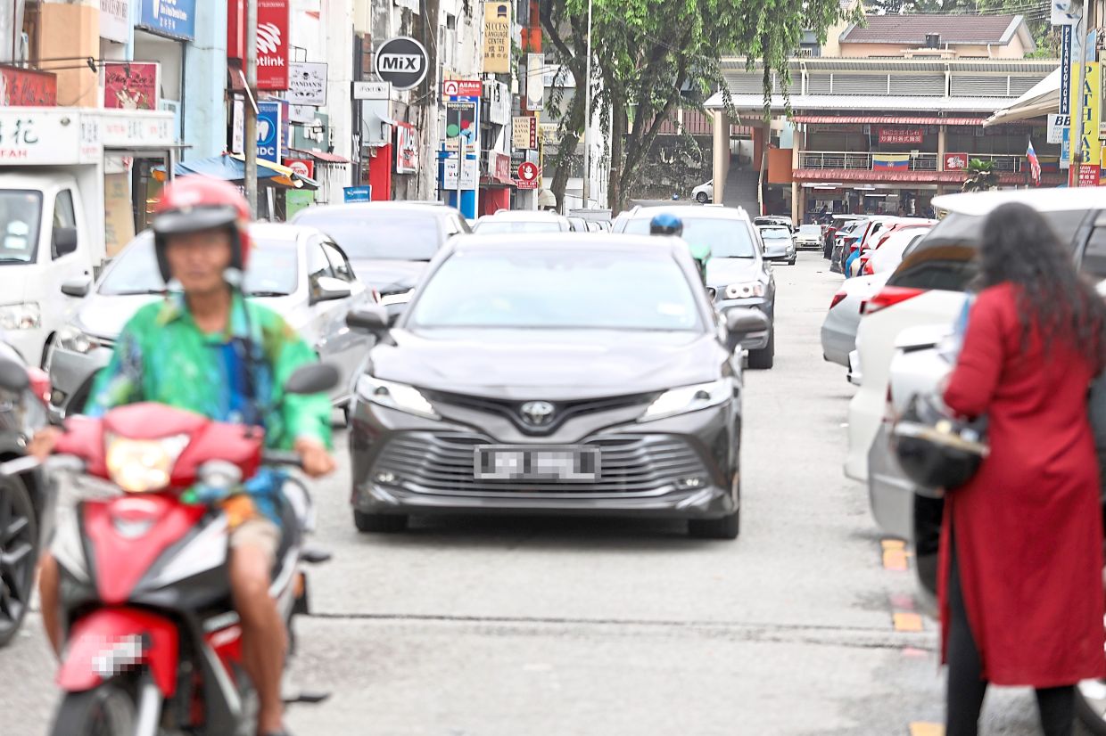 Jalan Mega Mendung is often congested due to double-parking. The revised plan to build a two-storey hawker centre at the former STP here in Taman United has raised concerns about parking and waste disposal.