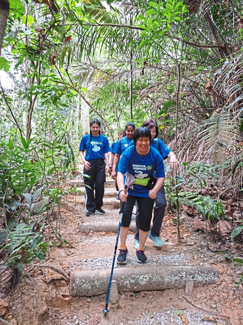 Neurotypical people are paired with individuals with intellectual and developmental disabilities for the hike.