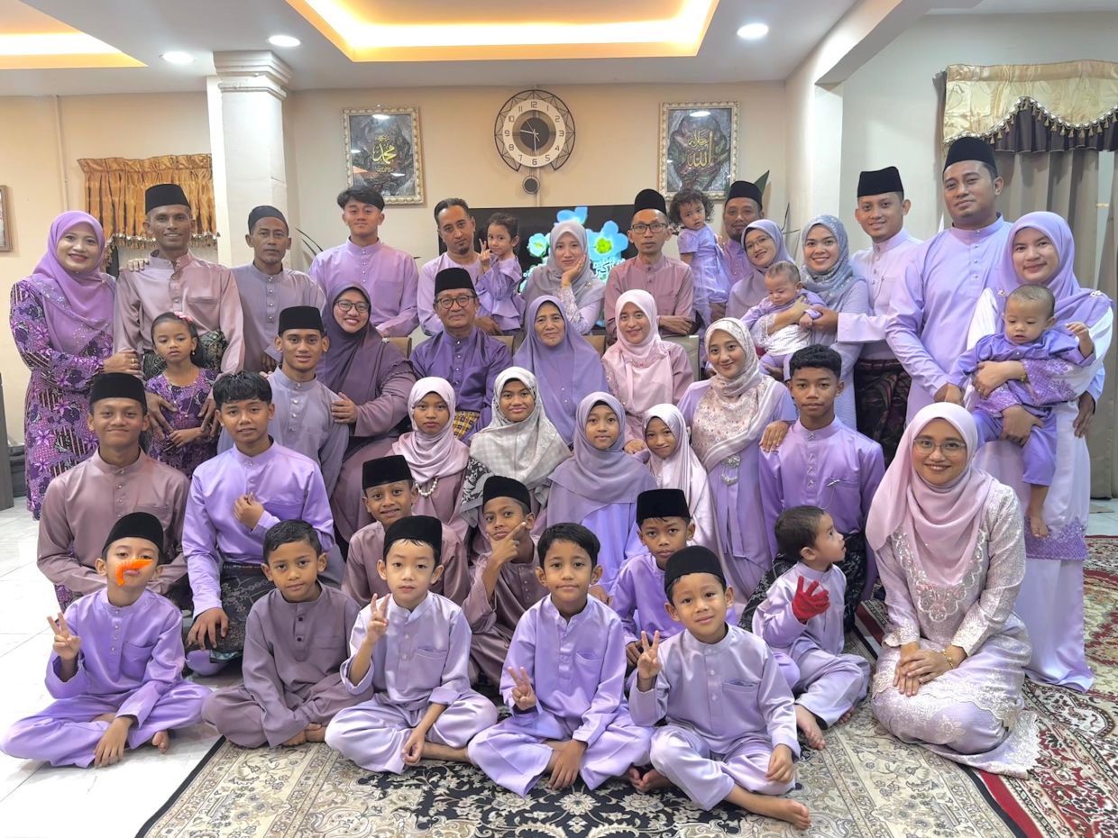 Matching outfits for Hari Raya: Wan Atikah with her siblings and extended family members, including nieces and nephews, as well as in-laws.