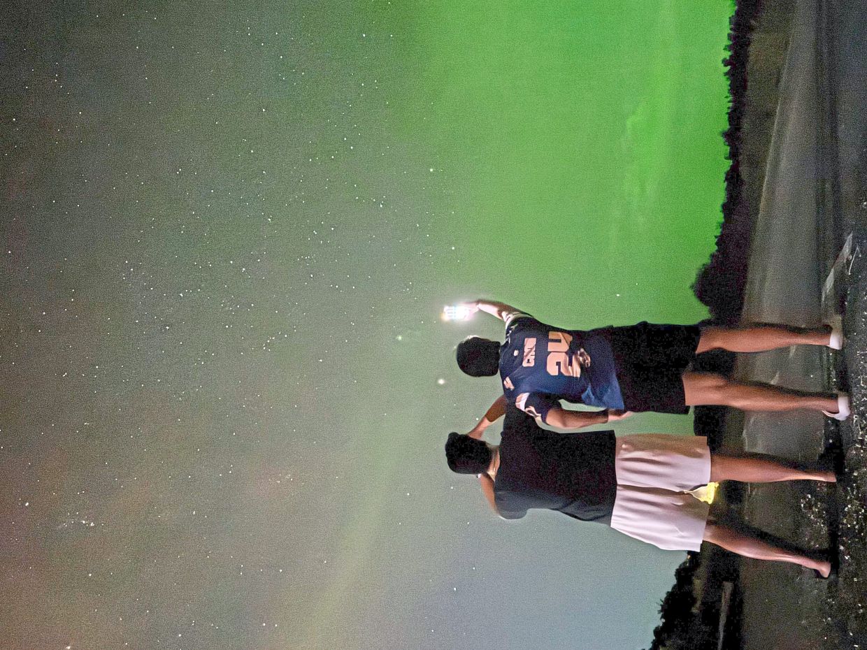 Two youngsters taking pictures of the night sky at the Selangor Observatory in Sungai Lang, Sabak Bernam. — GRACE CHEN/The Star