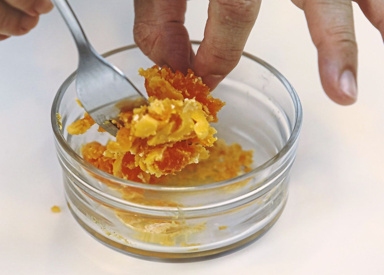 Separate the salted egg yolks from whites and steam them for about 10 minutes until cooked, then mash them up into coarse crumbs.
