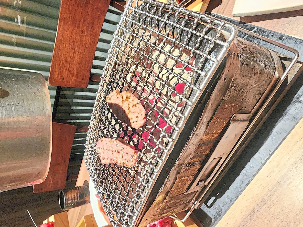Yakiniku involves grilling meat and other ingredients over a charcoal fire.