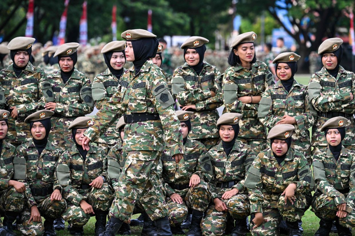 Cadets of the Komponen Cadangan (Komcad), the Reserve Component of the Indonesian National Armed Forces (TNI), take part in a graduation ceremony after three months of military basic training, in Banda Aceh on Saturday, July 12, 2025. -- Photo by CHAIDEER MAHYUDDIN / AFP