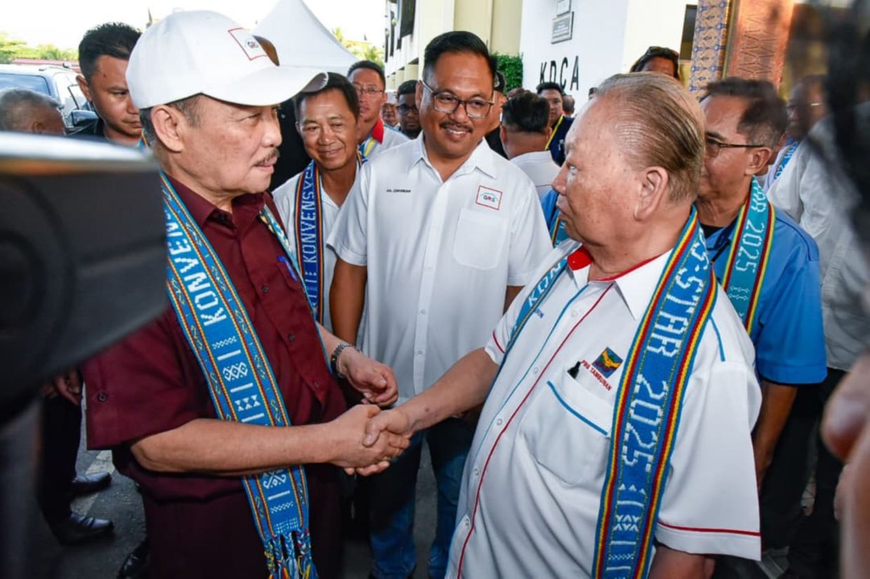 Parti Bersatu Sabah founder Tan Sri Joseph Pairin Kitingan (right) shakes hands with Chief Minister Datuk Seri Hajiji Noor after the PBS–Sabah STAR Convention at the Hongkod Koisaan in Penampang on Saturday (July 12).