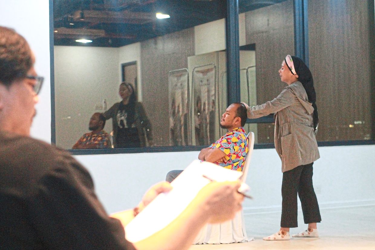 Aloy and Fazleena act out an intense scene while Syahrul reads through the script during a recent rehearsal in Petaling Jaya. Photo: The Star/M. Irsyad