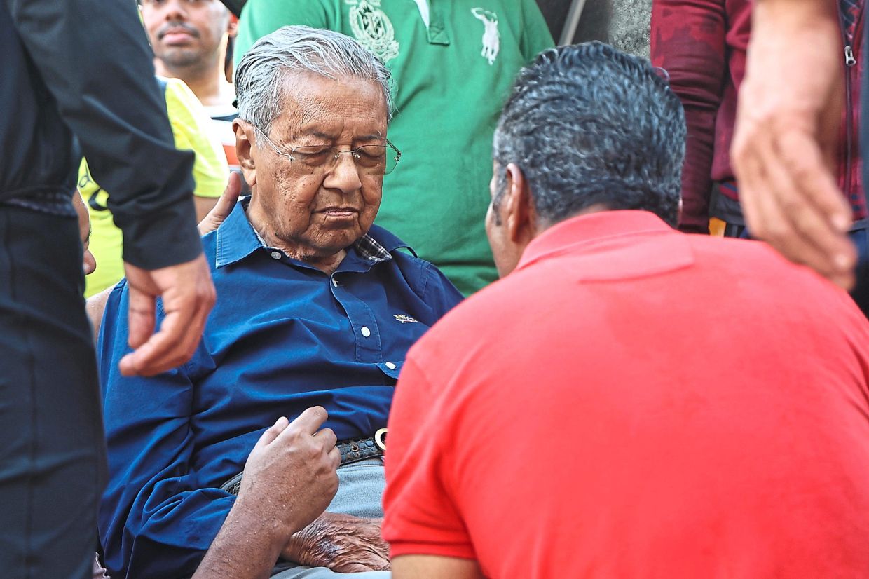 Taking a breather: Dr Mahathir is seen resting at the ‘Picnic and Potluck’ event in conjunction with his 100th birthday at Perdana Leadership Foundation in Putrajaya. — AZMAN GHANI/The Star 