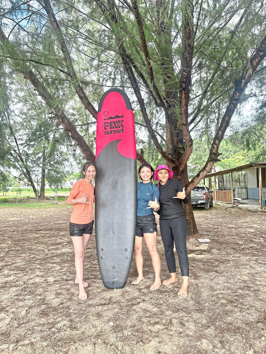 Nurain (right) founded her own surf school in Cherating. — NURAIN MAT ISA