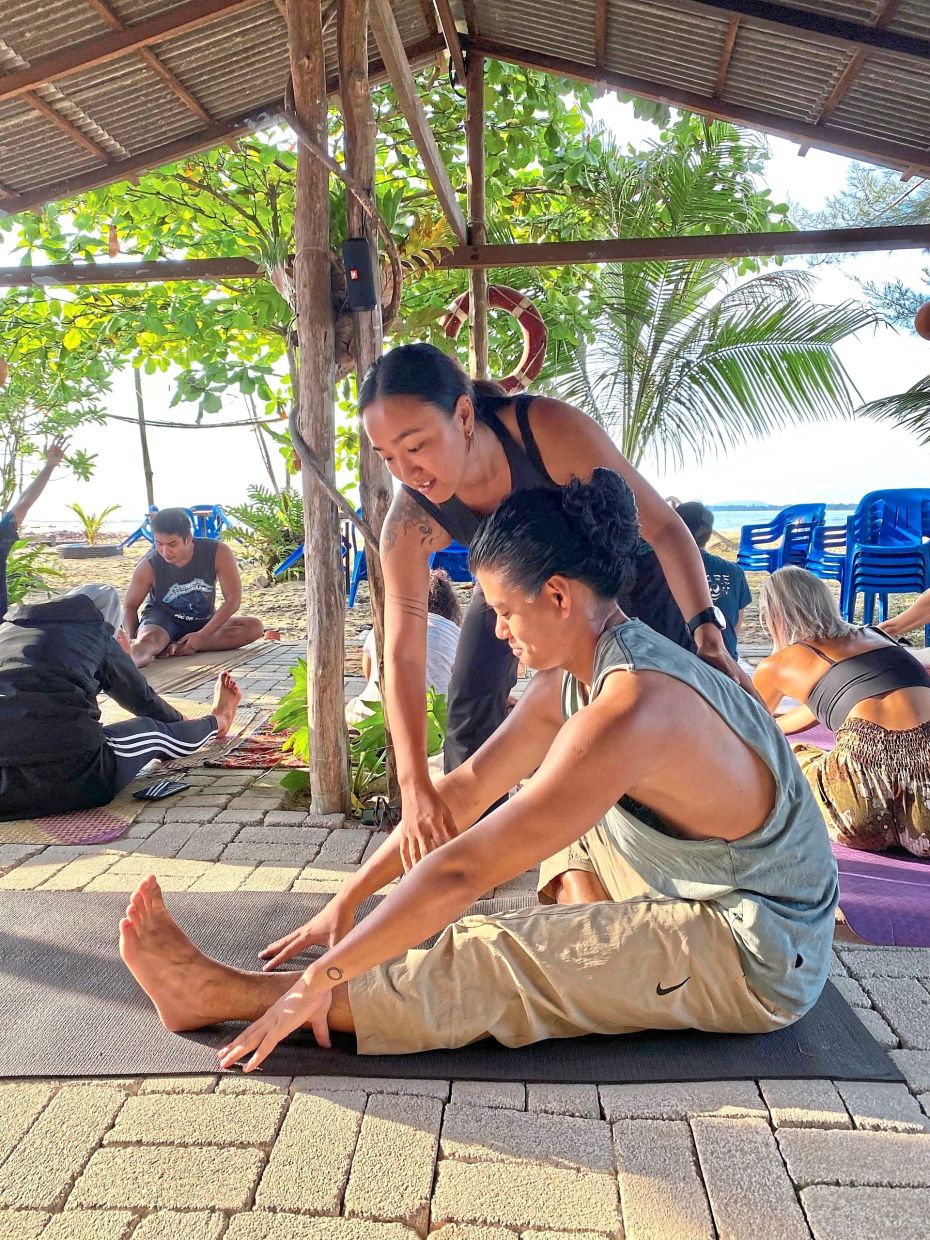 Moujing (in black) runs a hostel and studio in Cherating. — HANNAH MOUJING