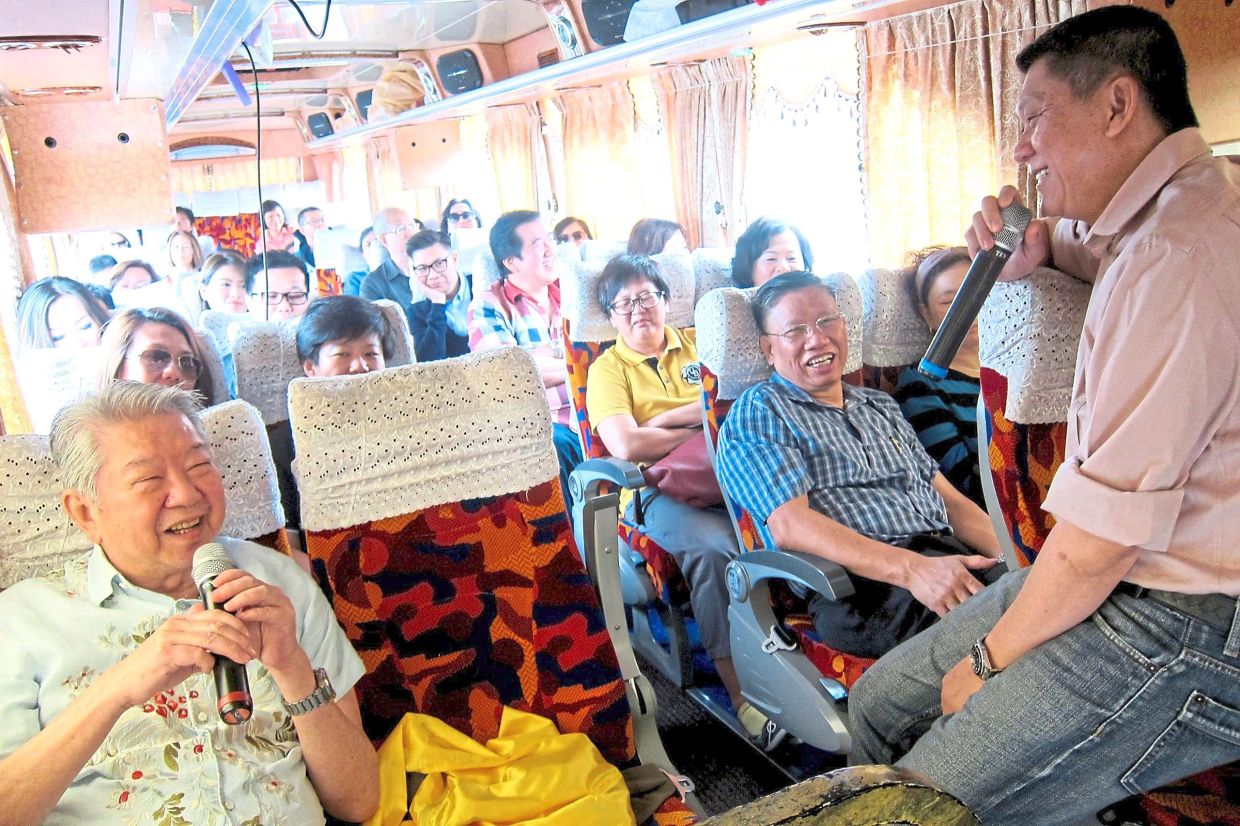 The writer (right) and Chua Lam entertaining their travel buddies during a trip to Taiwan.