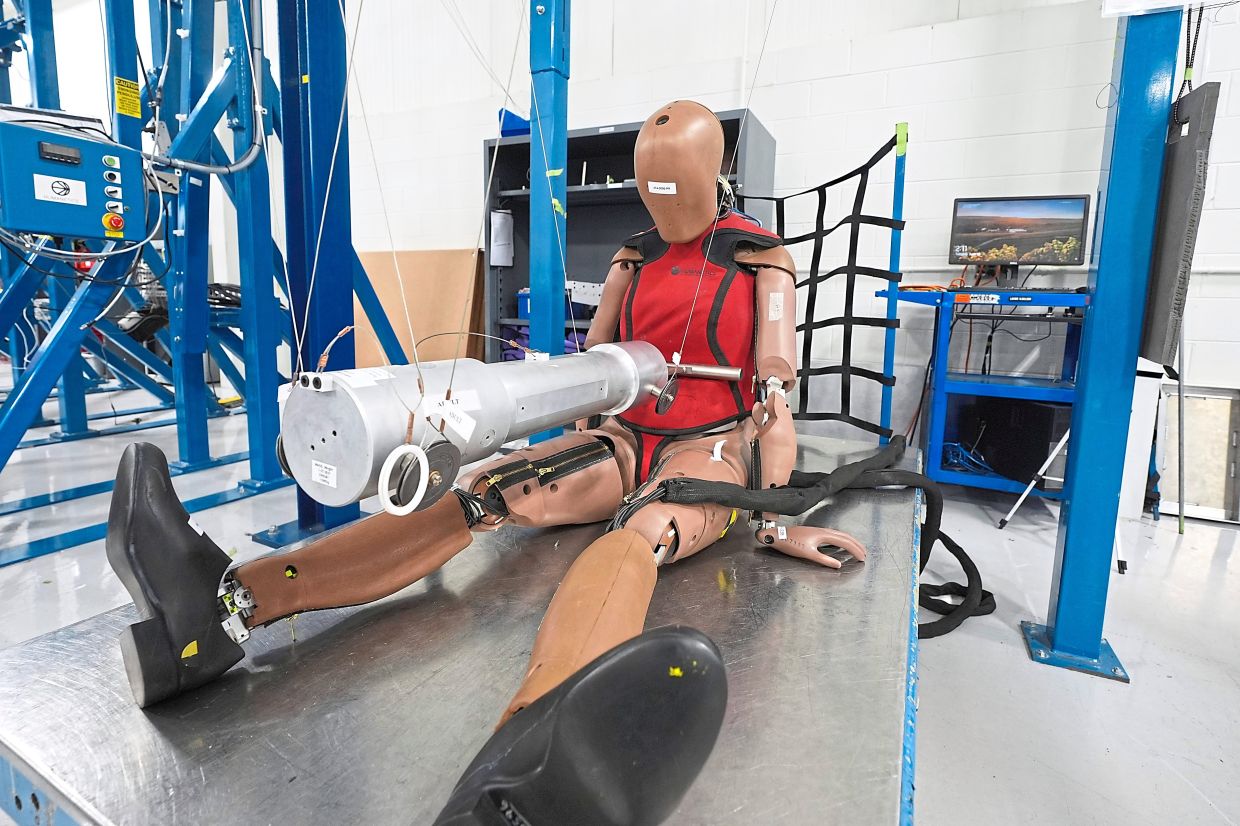A female crash test dummy is shown on an impact rig. Photo: PAUL SANCYA/AP