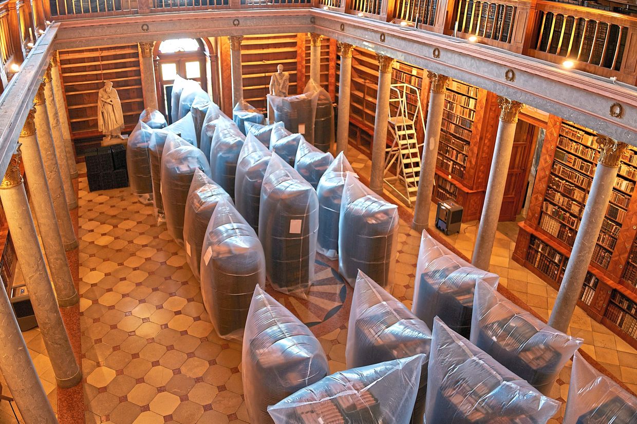 Books are kept in hermetically sealed plastic sacks for disinfection at the Pannonhalma Archabbey's library in Pannonhalma, Hungary. Photo: AP 