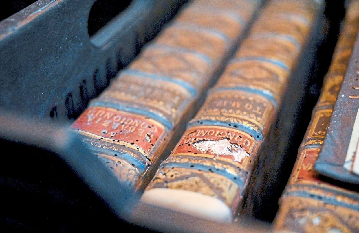 The extent of structural damage of old books due to a drugstore beetle infestation at the Pannonhalma Archabbey's library in Pannonhalma, Hungary. Photo: AP 