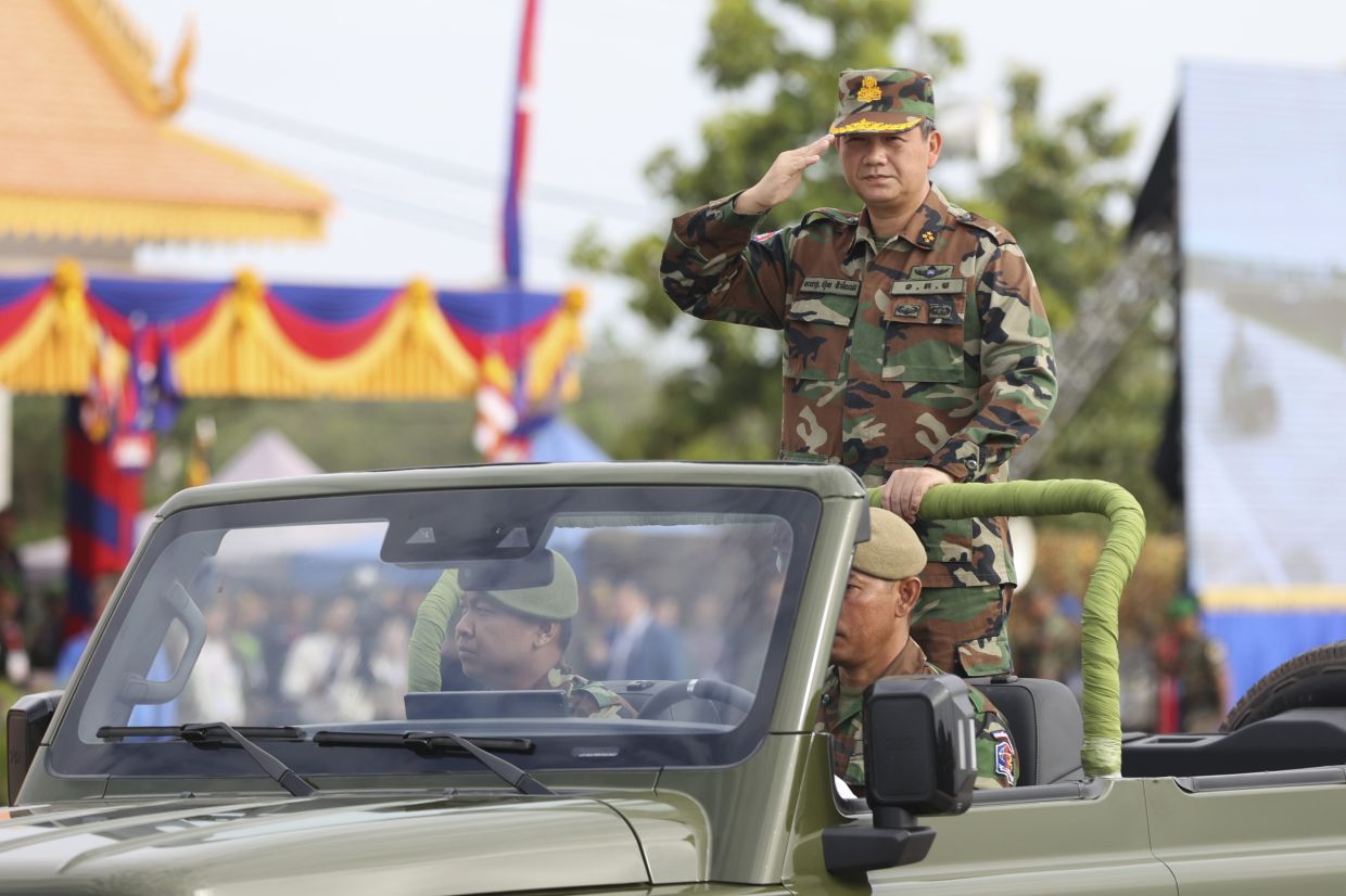 Cambodian Prime Minister Hun Manet reviews his troop from a vehicle during ceremony to put in used the military building in northern Kampong Chhnang province, Monday, July 14, 2025. -- AKP via AP