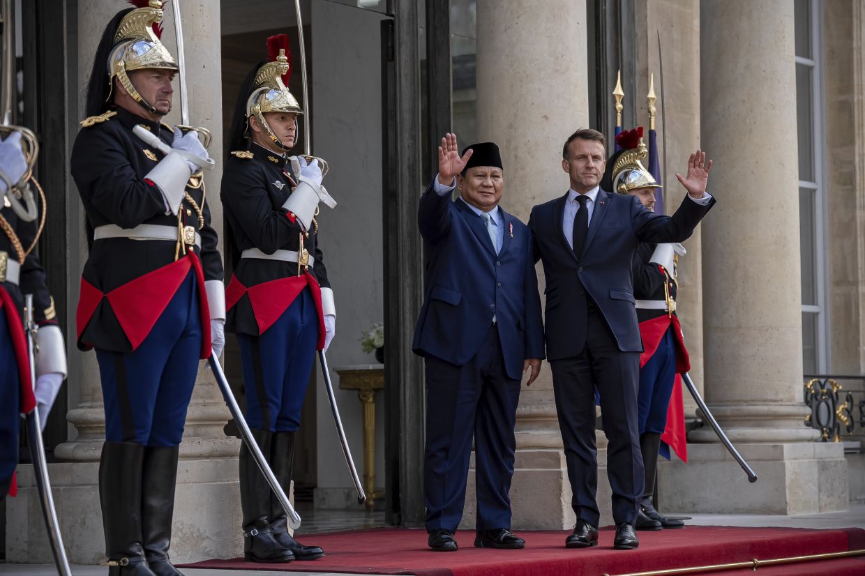French President Emmanuel Macron, right welcoming Indonesia's President Prabowo Subianto at the Elysee Palace in Paris n July 14. - AP Photo