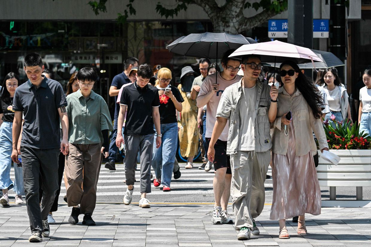 China is experiencing a relentless heatwave, with temperatures forecast to exceed 40 deg C in parts of the country as residents prepare for the summer season to reach its peak on July 20. - AFP