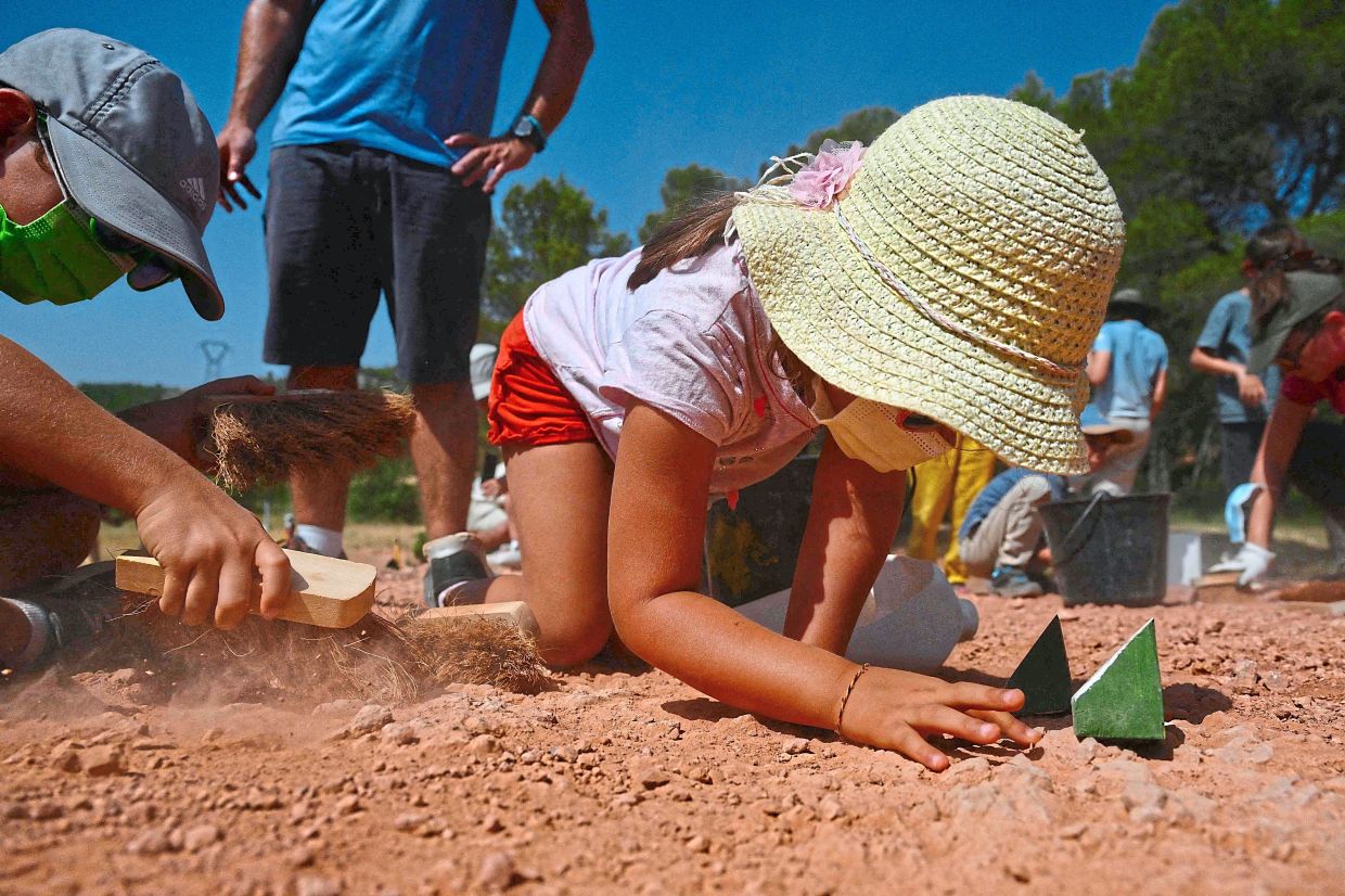 Children searching for dinosaur eggs at the Mount Sainte-Victoire site, near Aix-en-Provence in southern France. 