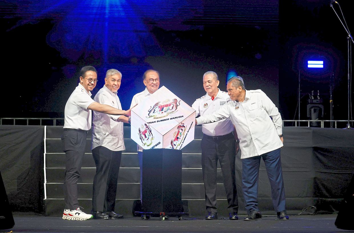 For the benefit of workers: Anwar (centre) launching the 2025 National Labour Day celebration at Axiata Arena, Bukit Jalil, in the presence of (from left) Human Resources Minister Steven Sim Chee Keong, Deputy Prime Ministers Datuk Seri Dr Ahmad Zahid Hamidi and Datuk Seri Fadillah Yusof and Chief Secretary to the Government Tan Sri Shamsul Azri Abu Bakar. — FAIHAN GHANI/The Star