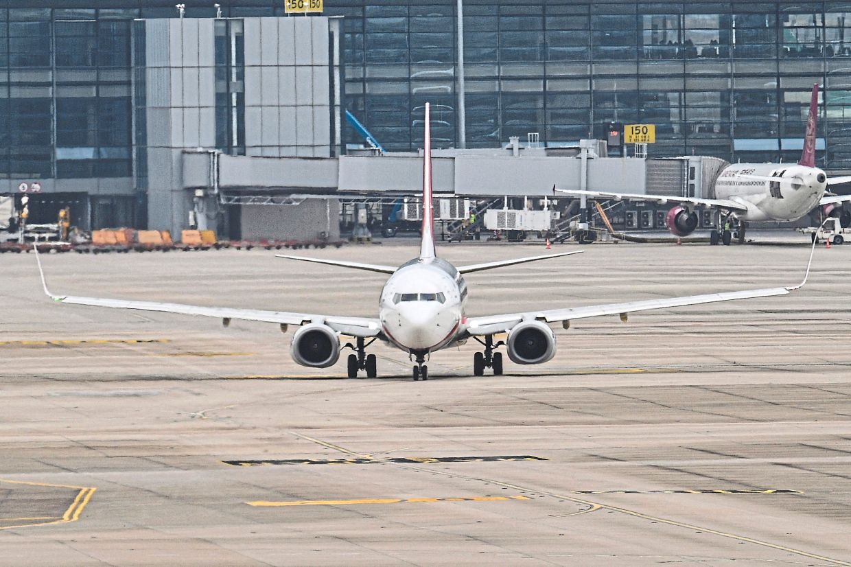 A Boeing 737-89P of Shanghai Airlines taxis at the Shanghai Pudong International Airport in Shanghai on April 17, 2025. (Photo by Hector RETAMAL / AFP)