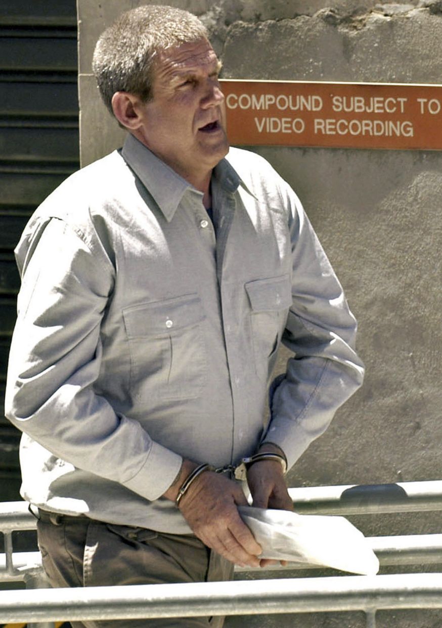 Bradley John Murdoch being led through the compound at the Adelaide Magistrates court on Nov. 13, 2003. - AP