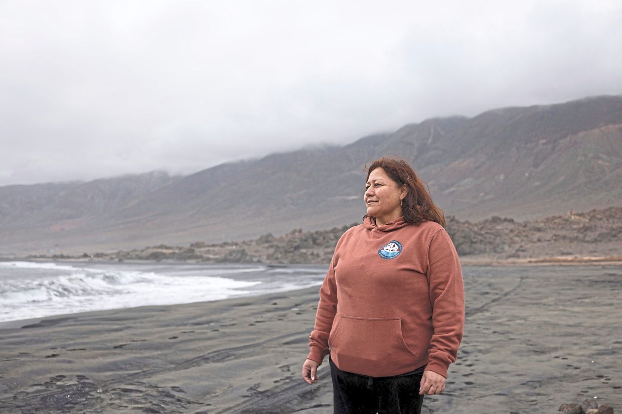 Espinoza on a beach, contaminated with mining waste. — Photo: PABLO SANHUEZA/Reuters 