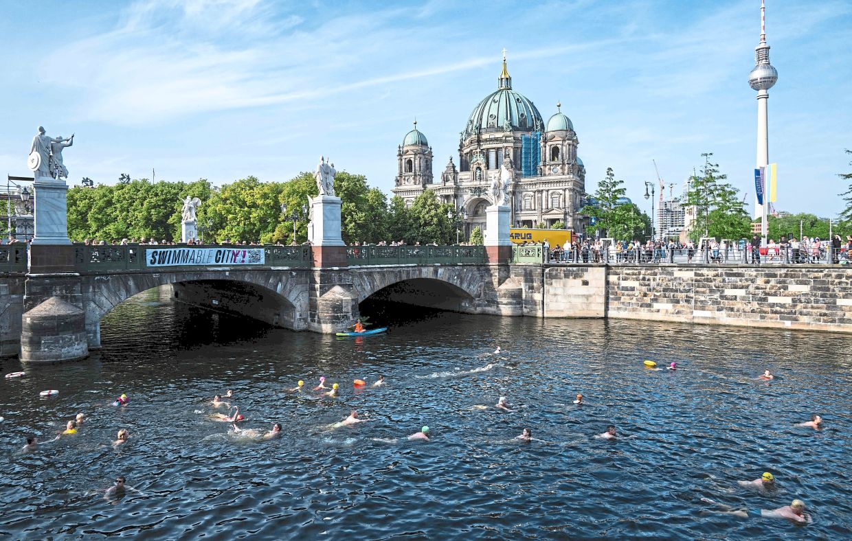 Swimmers in the Spree canal. The protesters have been lobbying for several years to open up the city's river for swimmers again. — Photos: JOHN MACDOUGALL/AFP