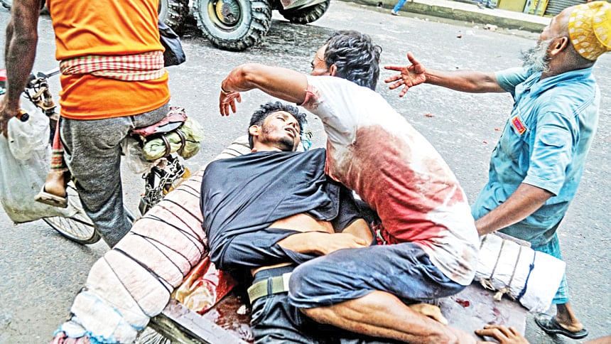 Locals were seen rushing an injured man to hospital on a rickshaw-van, - Photo: AFP