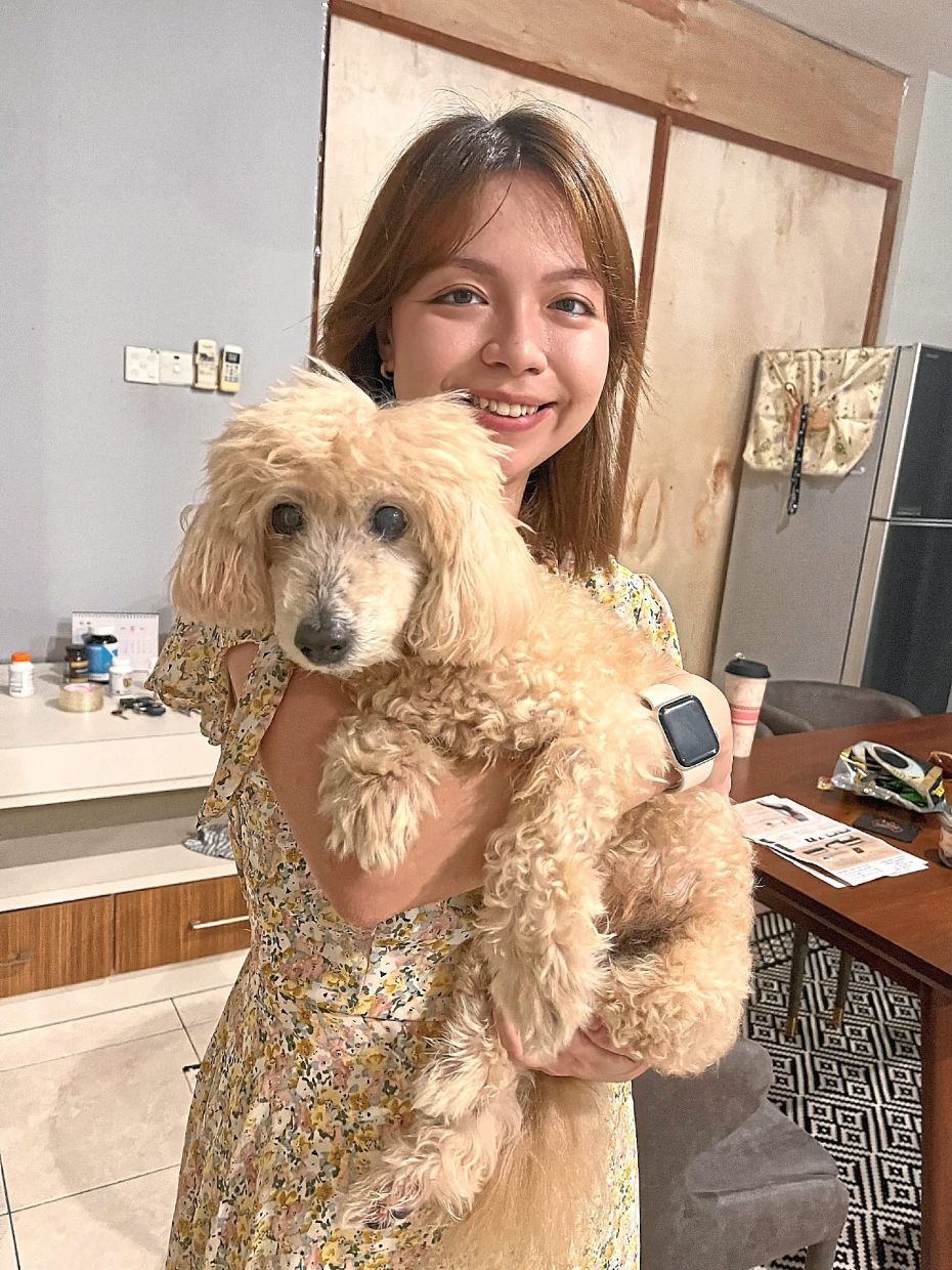 Samantha Poh with Jasper, her happy toy poodle.