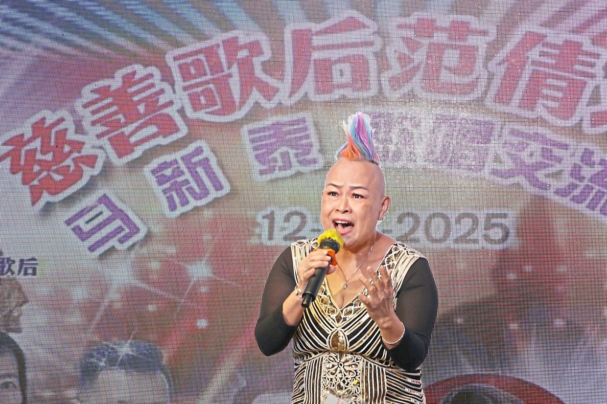 Lee with her eye catching rainbow hairstyle performing on stage.