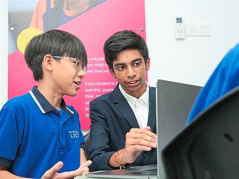 Aditya (right) and editorial member Damien Chong share a passion for expressing themselves through writing.