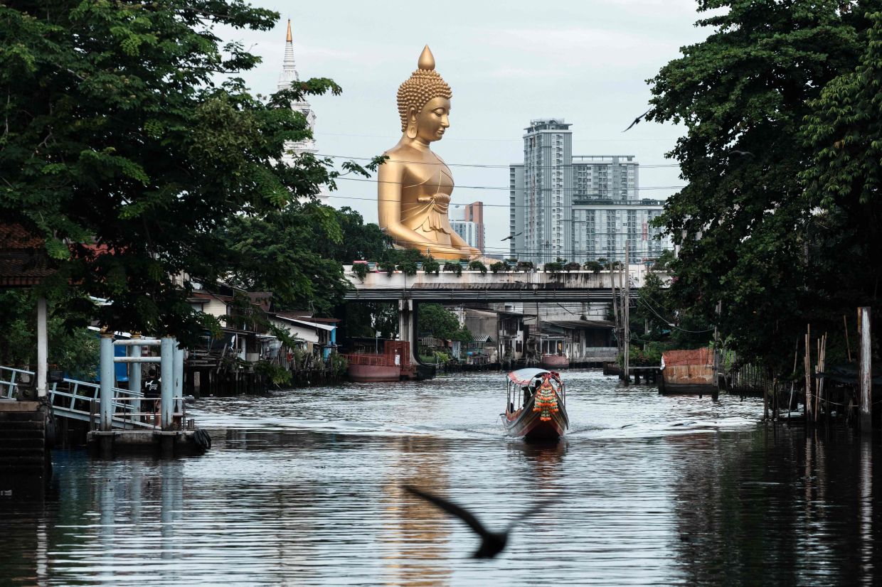 A 69-meter-tall giant Buddha statue stands at the Wat Paknam Phasi Charoen temple in Bangkok on Friday, July 18, 2025. -- Photo by Chanakarn Laosarakham / AFP