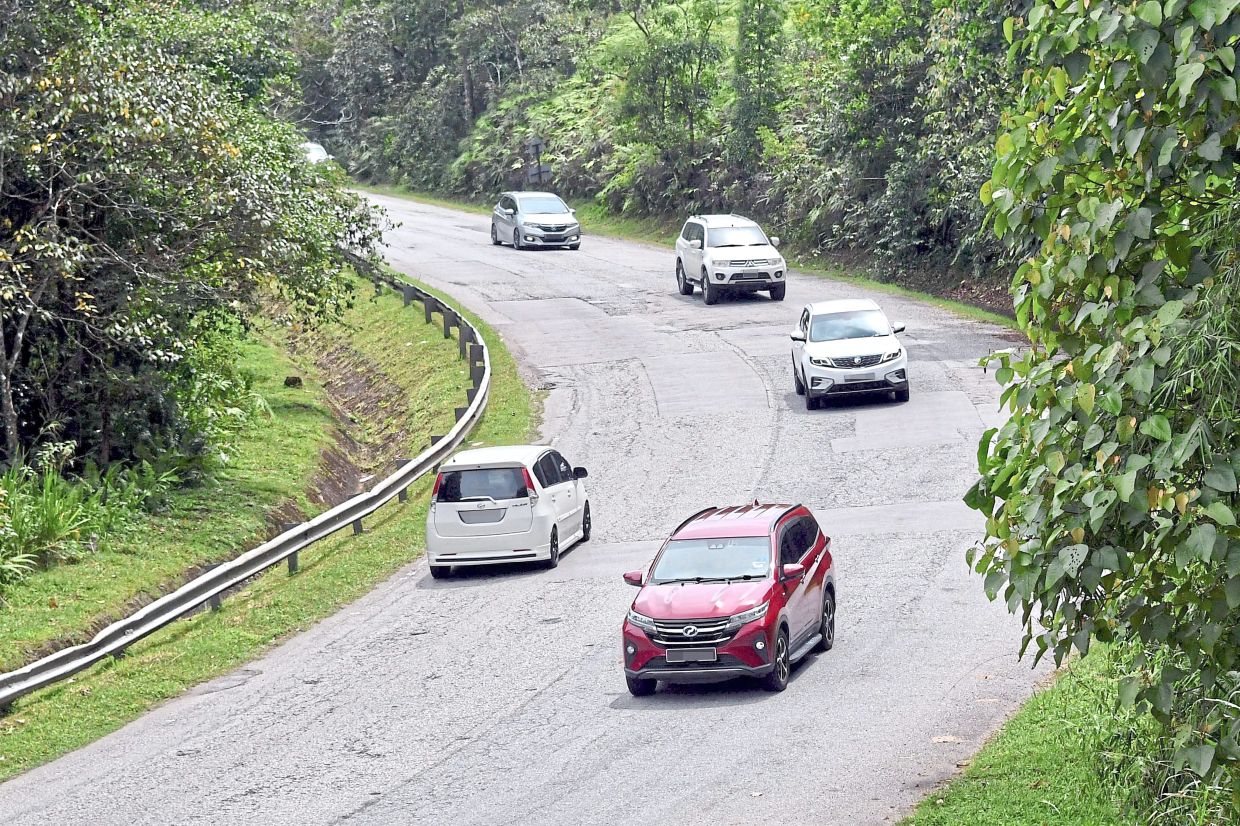Drivers have to navigate many sharp corners on the East-West Highway, completed in 1982, which lack clear road markings. — Photos: Bernama