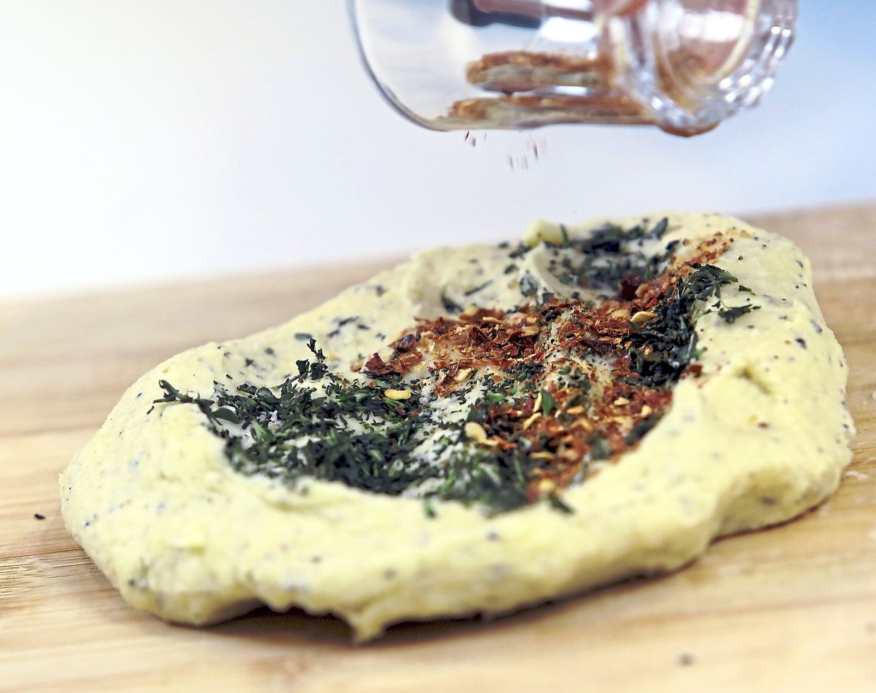 Mix the chilli flakes and thyme into the chilled dough.