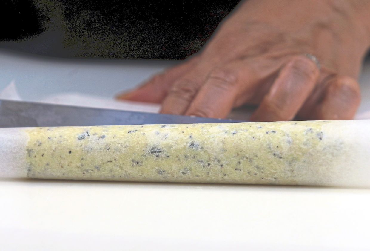 Use parchment paper to shape the dough into a log.