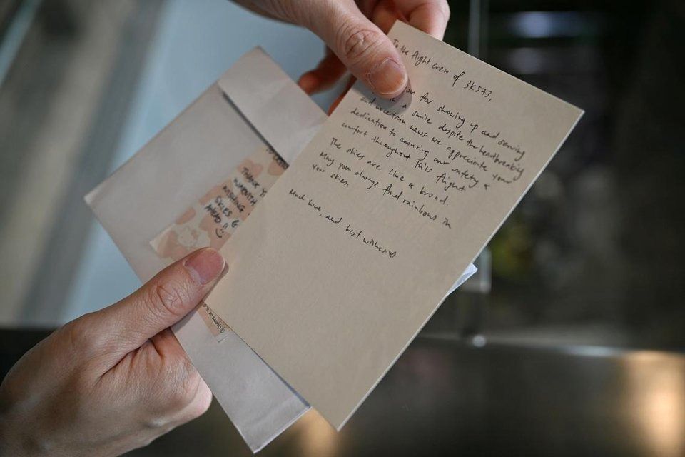 Wayne Lee, 42, an in-flight customer service manager with Jetstar Asia, shows the note a passenger left for him. - Photo: ST