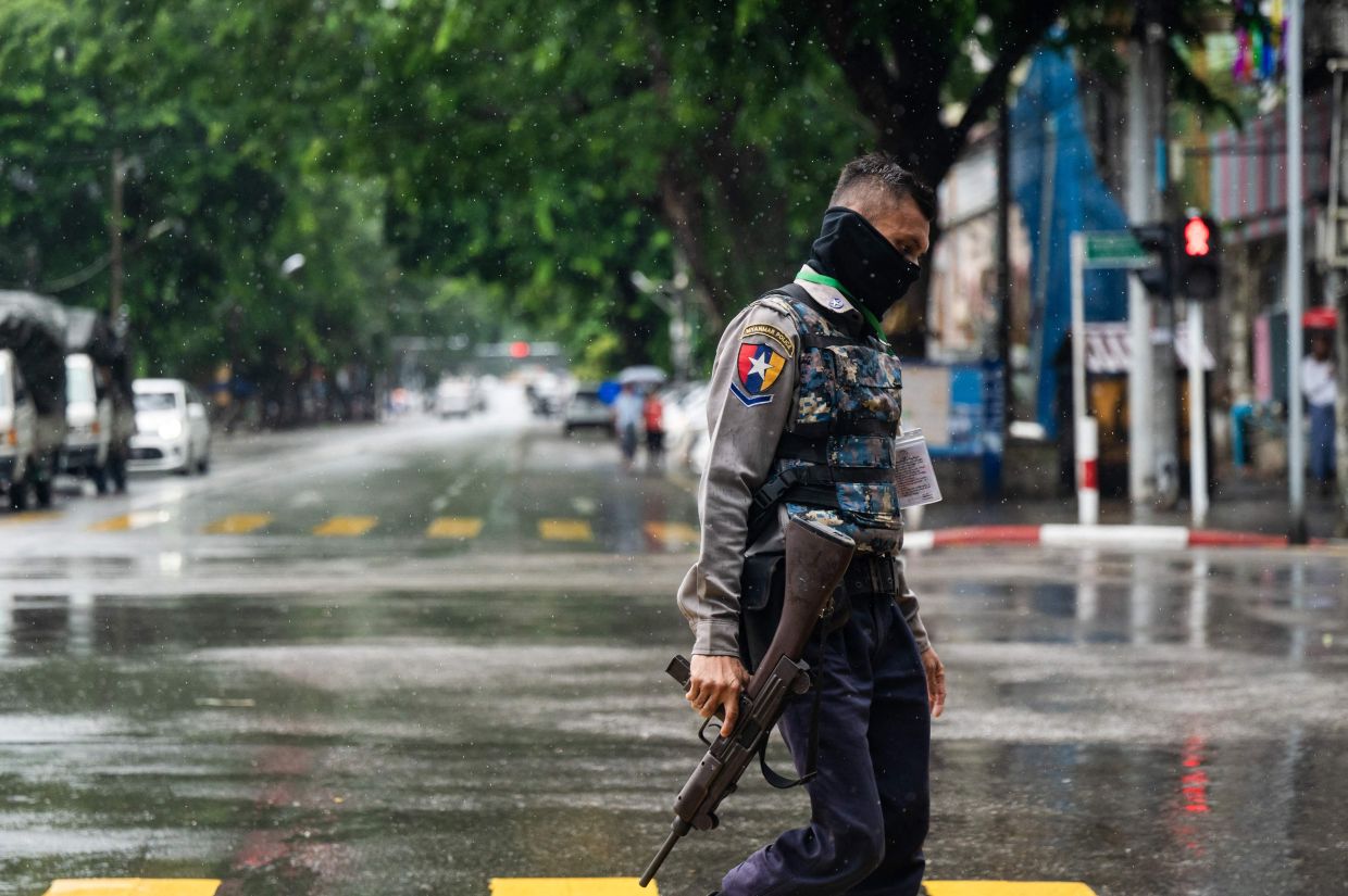 A policeman walks on a street in Yangon on Saturday, July 19, 2025, on the 78th Martyrs' Day that marks the anniversary of the assassination of independence leaders, including General Aung San, father of the currently deposed and imprisoned leader Aung San Suu Kyi. - Photo by AFP