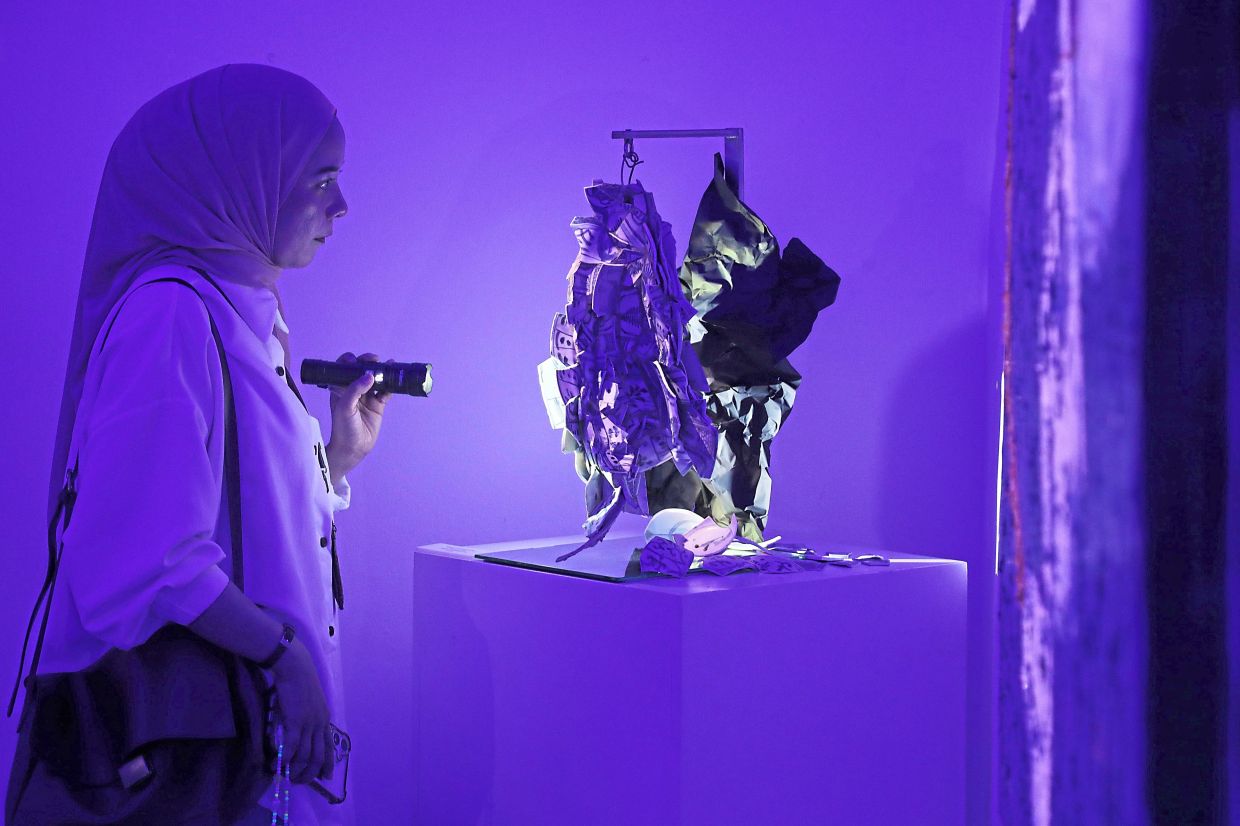 Flashlights are available for visitors to explore the artworks in detail. Photo: The Star/Yap Chee Hong