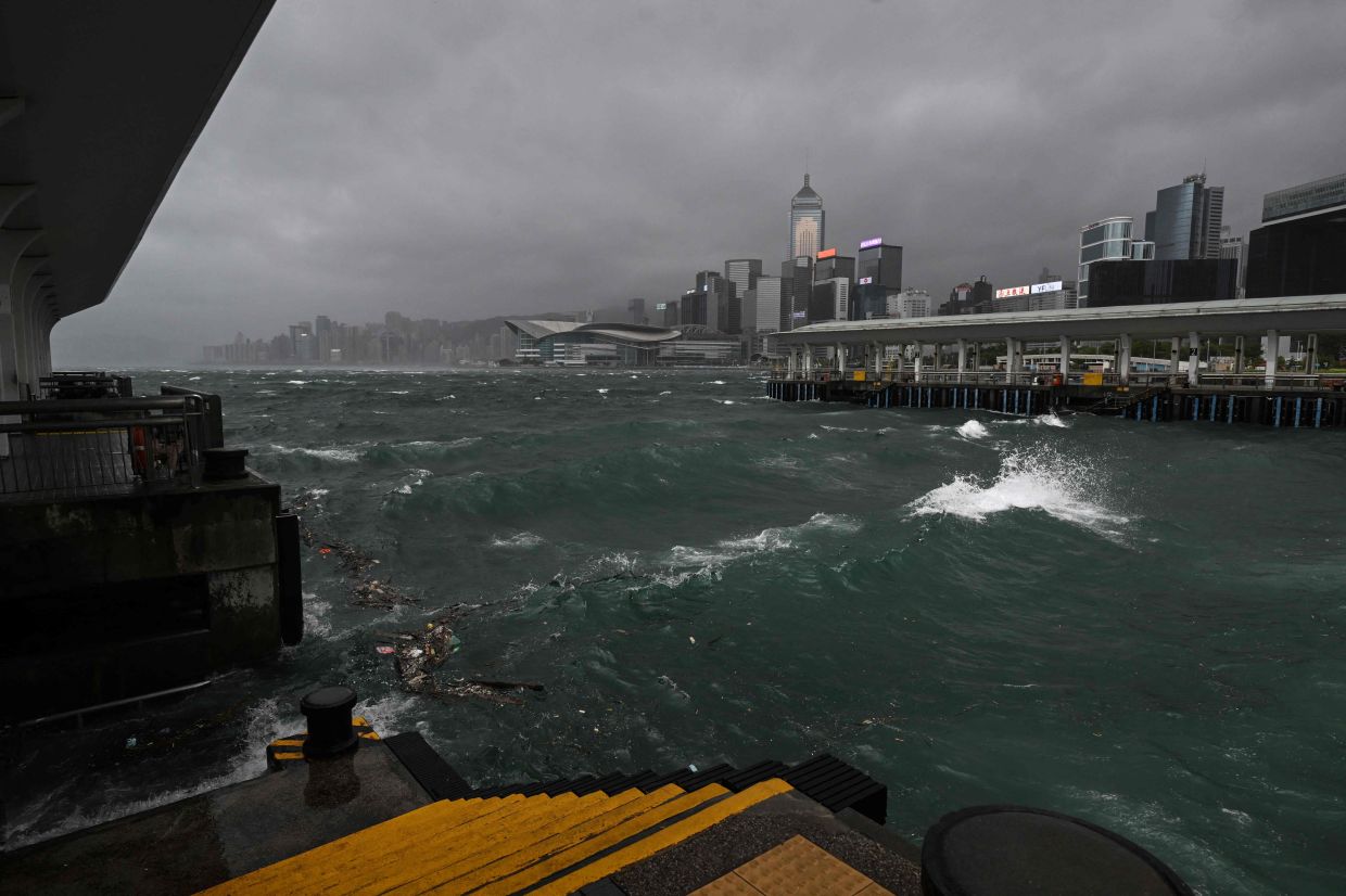 Dark clouds gather and rough seas are seen in Victoria harbour as the typhoon signal number 10 is hoisted as Typhoon Wipha moves towards Hong Kong on July 20, 2025. - Photo: AFP