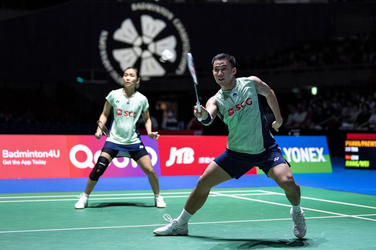 Thailand's Dechapol Puavaranukroh and Supissara Paewsampran play a point against China's Jiang Zhenbang and Wei Yaxin during their mixed doubles final match on the final day of the Japan Open badminton tournament at Tokyo Gymnasium in Tokyo on Sunday, July 20, 2025. -- Photo by Yuichi YAMAZAKI / AFP