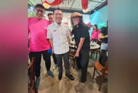 Best foot forward: Nga struts out in Malaysian-made firemen's shoes
