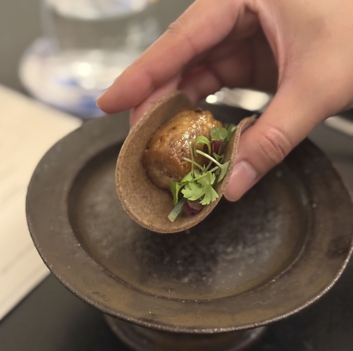 The first part of the main course is meant to be eaten like a taco.