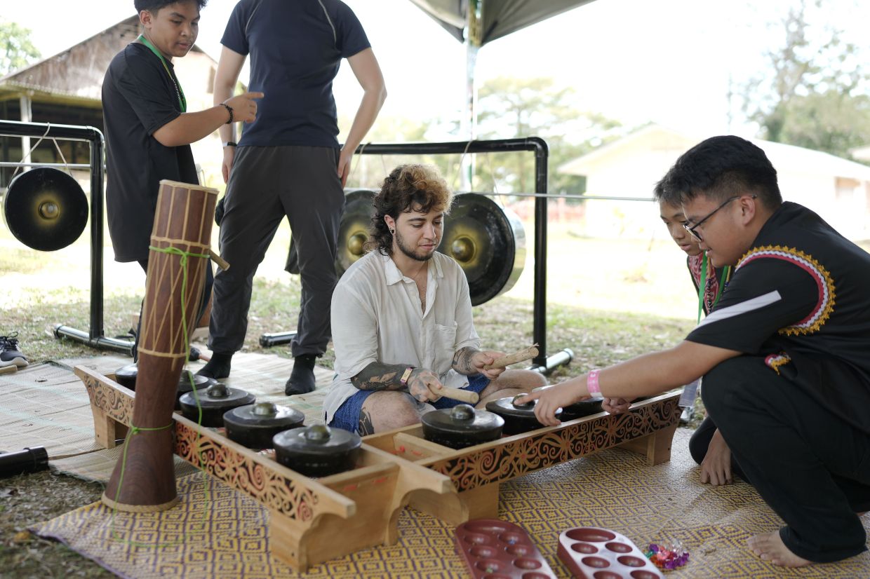 A festival goer trying out the traditional gamelan.