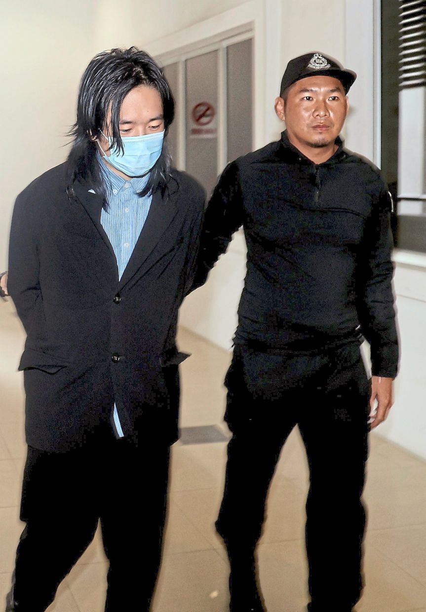 Day in court: You being escorted to the Shah Alam Sessions Court. — KK SHAM/The Star