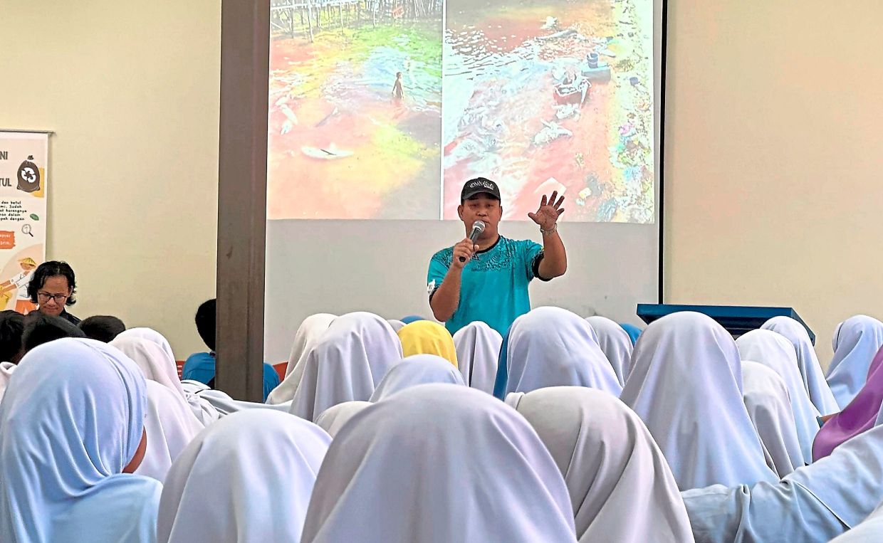 Adzmin giving a talk on marine pollution and waste awareness to school students in Semporna.