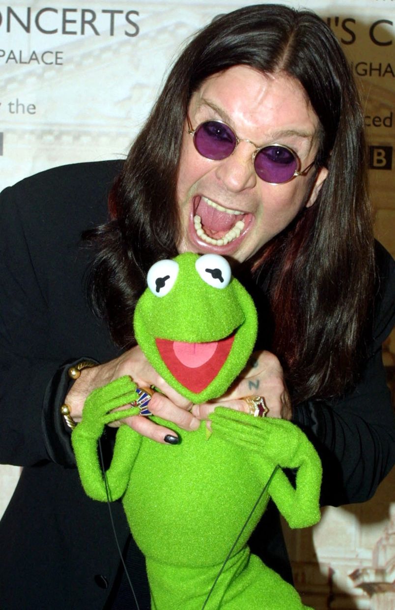 British rock star Ozzy Osbourne (L) and Kermit the Frog (R) pose for photographs after the Golden Jubilee Pop Concert at Buckingham Palace in London June 3, 2002. Around 12,000 members of the public attended a concert hosted by Britain's Queen Elizabeth II which featured music from Sir Paul MaCartney, Eric Clapton and Tom Jones among others. REUTERS/Stringer/File Photo