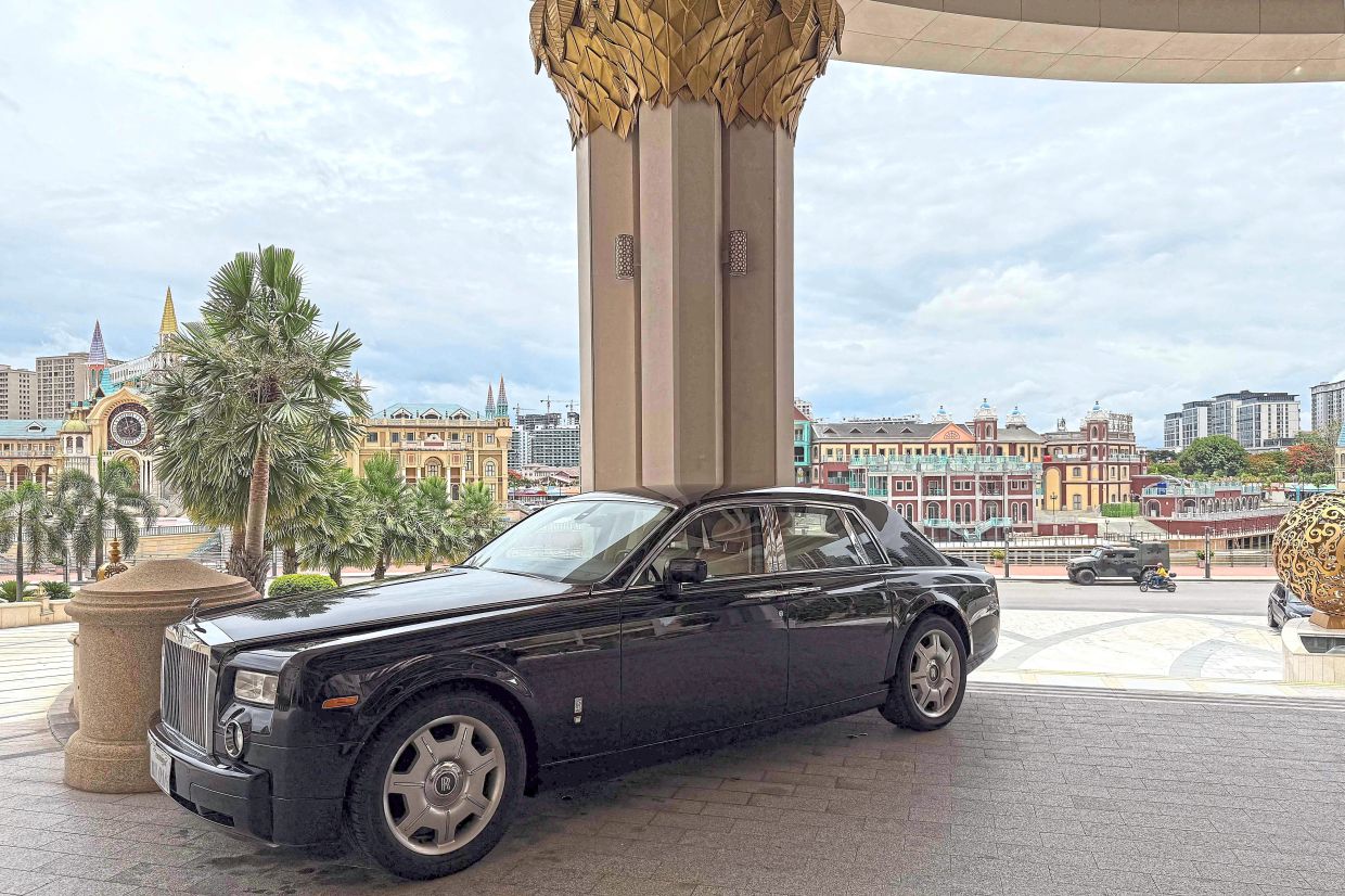 A Rolls-Royce is parked in front of the main entrance to the Kings Romans Casino. — AFP
