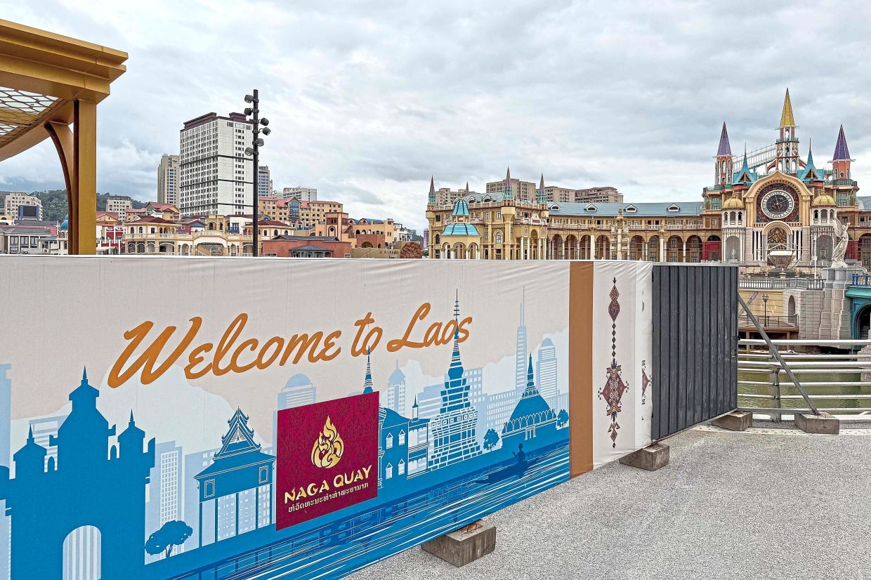 Not what it seems: A ‘Welcome to Laos’ sign is seen at the Diamond Plaza tourist attraction inside the GTSEZ. — AFP