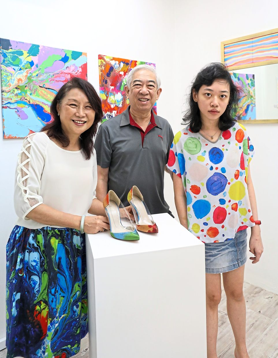 Janet (right), pictured with her parents, has a legacy that lives on through her art (featured onfashion). The Star/Samuel Ong
