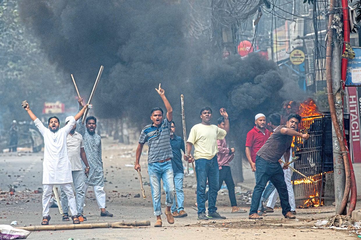 Students clashing with police during a protest in Dhaka in this file photo. — AP