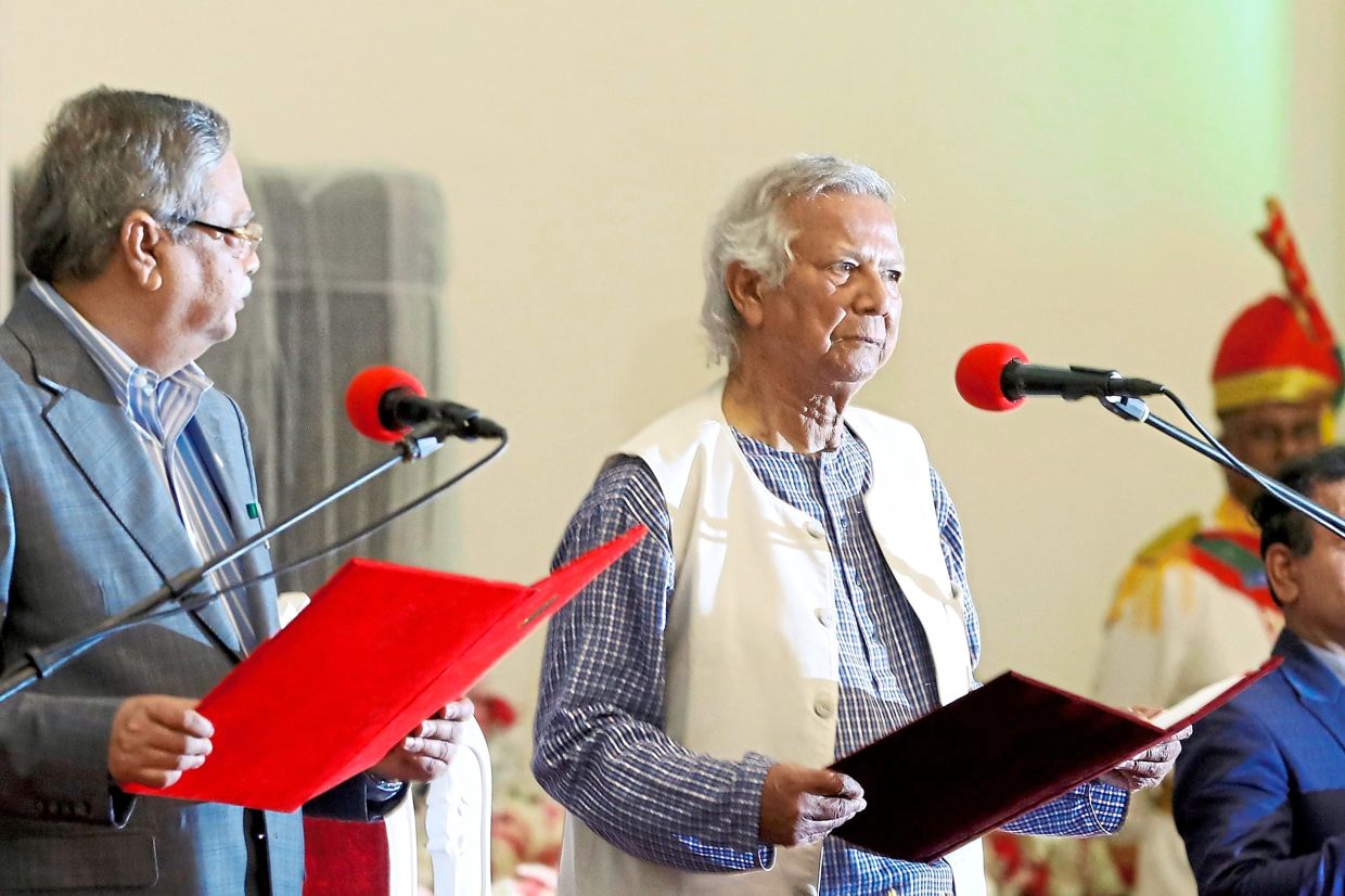 New leadership: Yunus taking the oath of office as the head of Bangladesh’s interim government on Aug 8, 2024. — AP
