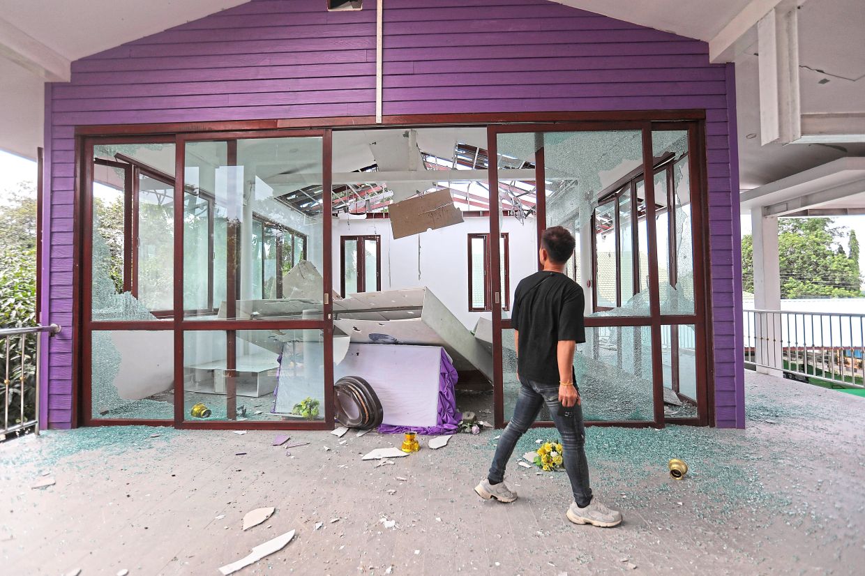 A man looking at the damage to Phanom Dong Rak hospital in Surin province, Thailand, after Cambodia fired artillery shells. — Agencies